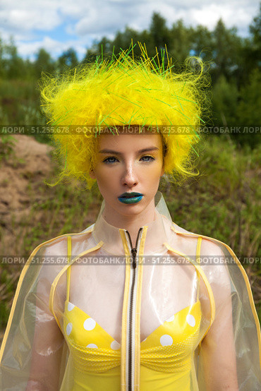 Sexy beautiful woman in a bright yellow wig and transparent raincoat. Стоковое фото, фотограф Андрей Аркуша / Фотобанк Лори