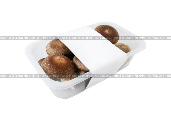 shiitake organic mushrooms for sale in a plastic tray on a light background. lentinula edible, Japanese forest mushroom. Стоковое фото, фотограф Оксана Медведева / Фотобанк Лори