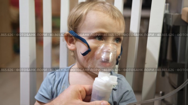 Sick Baby Girl with making Inhalation with a Mask on his Face sitting in Living Room at Home. Children Healing. Child Inhalation therapy with Compressor nebulizer. Inhaling fumes medication into lungs. Стоковое видео, видеограф Марина Демидюк / Фотобанк Лори