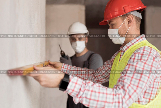 side view men working with masks. Стоковое фото, агентство Ingram Publishing / Фотобанк Лори