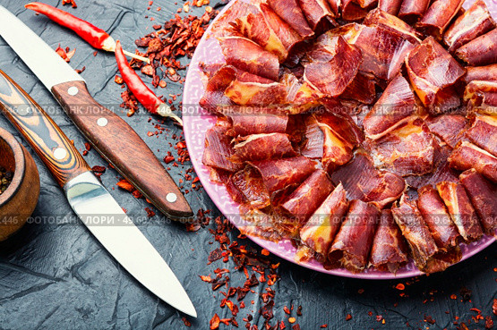 Sliced basturma or beef jerky.Horse meat jerky.Armenian cuisine. Beef cured and spice,basturma. Стоковое фото, агентство Ingram Publishing / Фотобанк Лори