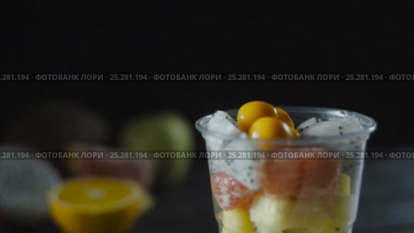 Slices of Cape Gooseberry Adds a Fruit Cocktail Cup. Стоковое видео, видеограф Станислав Панкратов / Фотобанк Лори