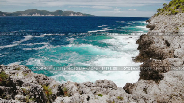 Slow motion of crystal clear waters of the Ionian Sea. Bluff coastline of Kefalonia Island. Sea wave. Стоковое видео, видеограф Igor Tichonow / Фотобанк Лори