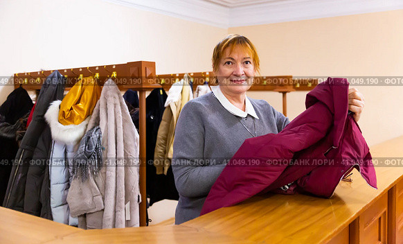 Smiling elderly woman checkroom attendant working in theater. Стоковое фото, фотограф Яков Филимонов / Фотобанк Лори
