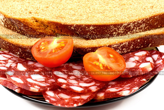 Smoked sausage, cherry tomatoes and bread on a white background. Стоковое фото, фотограф Artem Sobov / Фотобанк Лори
