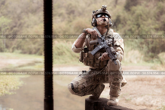 Soldiers in camouflage military uniforms carrying weapons, Reconnaissance missions in the tropical forest area, Assault infantry battle training. Стоковое фото, агентство Ingram Publishing / Фотобанк Лори