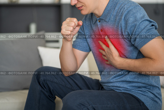 Sore throat and cough, man with lung pain at home. Стоковое фото, фотограф Станислав Тарко / Фотобанк Лори
