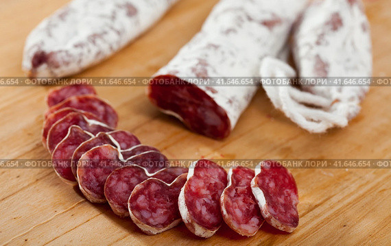 Spanish sausage fuet on a wooden table, closeup. Стоковое фото, фотограф Яков Филимонов / Фотобанк Лори