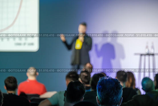 Speaker presenting to audience at business event with presentation screen. Стоковое фото, фотограф Антон Гвоздиков / Фотобанк Лори