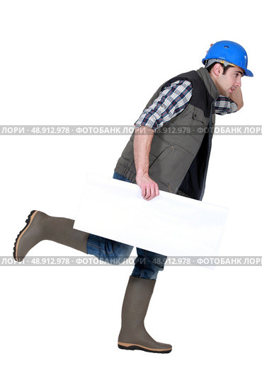 Speedy tradesman holding a blank sign. Стоковое фото, агентство Ingram Publishing / Фотобанк Лори