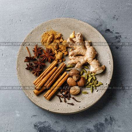 Spice Ingredient - allspice, anise star, cardamon, cinnamon stick, ginger root, nutmeg - for Mulled wine hot drink on concrete background. Стоковое фото, фотограф Лисовская Наталья / Фотобанк Лори