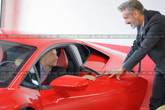 sports car dealer and his customer. Стоковое фото, агентство Ingram Publishing / Фотобанк Лори