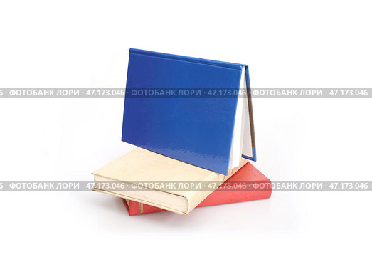 Stack of red, yellow and blue books isolated on a white background. Стоковое фото, фотограф Елена  Попкова / Фотобанк Лори