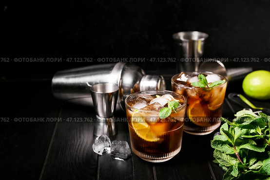 Стаканы холодного коктейля Cuba Libre на темном фоне. Стоковое фото, фотограф Pixel_shot / Фотобанк Лори