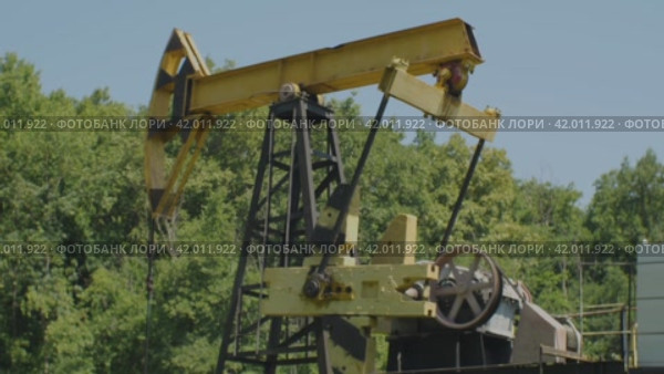 Старая нефтяная вышка качает сырье из скважины. Промышленное оборудование. Концепция нефтегазовой промышленности. Стоковое видео, видеограф Воловодов Владимир / Фотобанк Лори
