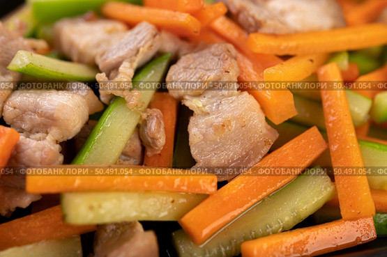 Stir-fried carrots and cucumber with pork belly. Стоковое фото, агентство Ingram Publishing / Фотобанк Лори