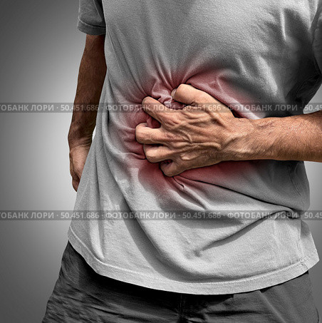 Stomachache Pain or painful stomach ache as an abdominal illness as Crohn’s disease or IBS and Ulcers representing intestinal inflammation or bloating. Стоковое фото, агентство Ingram Publishing / Фотобанк Лори