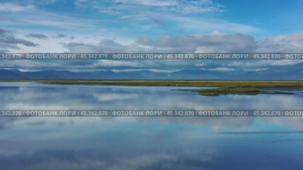 Stones with reflection in smooth water. Стоковое видео, видеограф Михаил Коханчиков / Фотобанк Лори