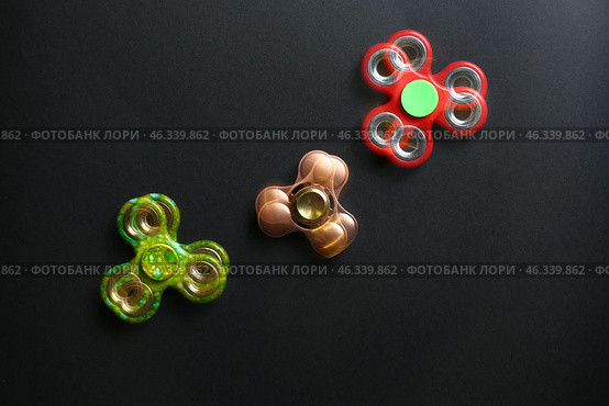 Stroboscopic photo of moving spinners on dark background. Стоковое фото, фотограф Pixel_shot / Фотобанк Лори