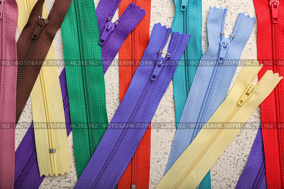 Stylish different zippers on light background, closeup. Стоковое фото, фотограф Pixel_shot / Фотобанк Лори