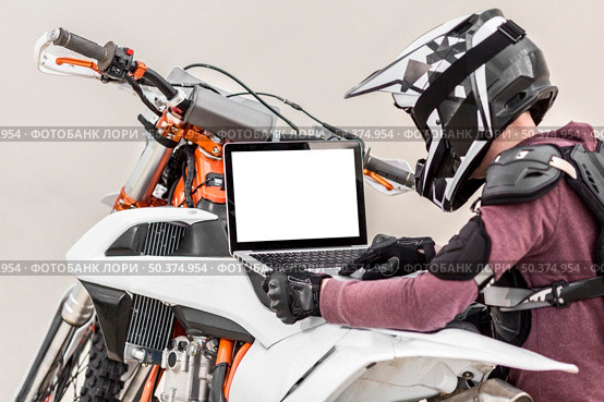 stylish rider trying diagnose motorbike problem. Стоковое фото, агентство Ingram Publishing / Фотобанк Лори