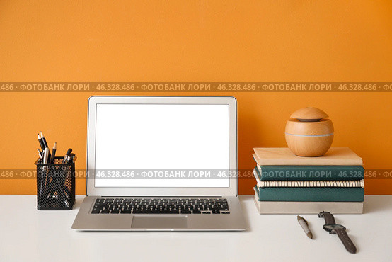 Stylish workplace with laptop near color wall. Стоковое фото, фотограф Pixel_shot / Фотобанк Лори