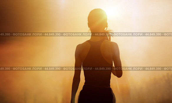 Successful, strong woman overcomes difficulties and runs towards her goals and achievements. Female silhouette on sunrise city background. Success Business Leadership. Стоковое фото, фотограф Павел Муравьев / Фотобанк Лори
