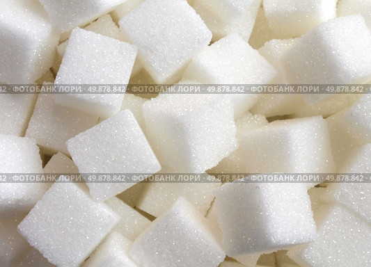 Sugar background sweet cube food ingredient background with a close up of a pile of delicious white lumps of cubes as a symbol of cooking and baking and the diet health risks related to diabetes and calorie intake. Стоковое фото, агентство Ingram Publishing / Фотобанк Лори