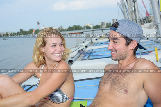 sunbathing on top of the sailboat. Стоковое фото, агентство Ingram Publishing / Фотобанк Лори
