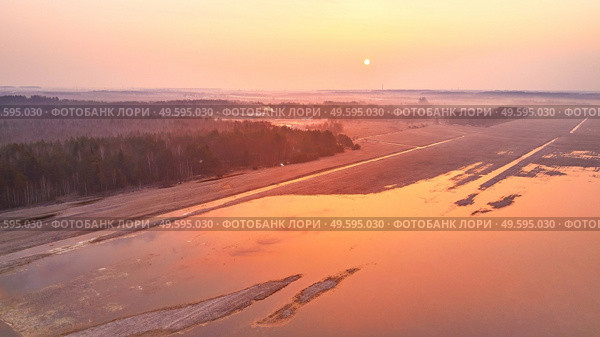 Sunrise spring melting river flood aerial panorama. Overflow water at springtime. Rural April landscape. Meadows covered by water. Morning flood-land near Neman, Belarus. . Стоковое фото, агентство Ingram Publishing / Фотобанк Лори