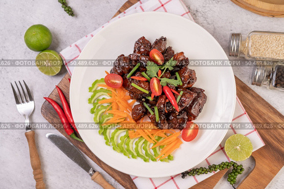 Sweet pork in a white plate with chopped scallions, chili, lime, gourd, tomato and garlic. Стоковое фото, агентство Ingram Publishing / Фотобанк Лори