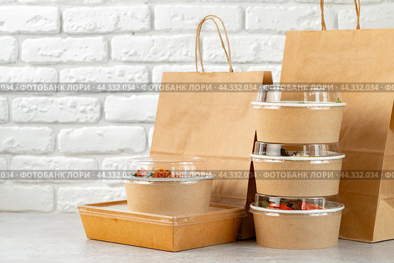 Take out food in boxes and craft bag against brick background. Стоковое фото, фотограф Сергей Толмачёв / Фотобанк Лори