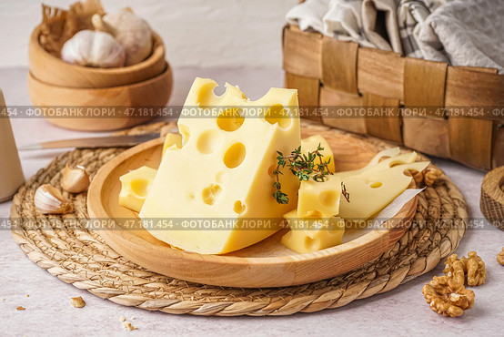 Тарелка с кусочками швейцарского сыра и грецким орехом на белом фоне. Стоковое фото, фотограф Pixel_shot / Фотобанк Лори