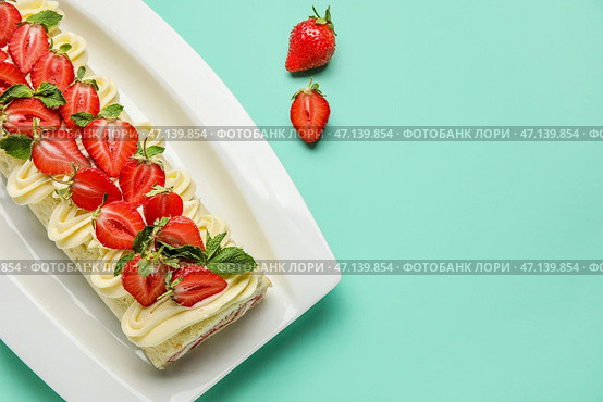 Тарелка с вкусным клубничным рулетом на цветном фоне. Стоковое фото, фотограф Pixel_shot / Фотобанк Лори