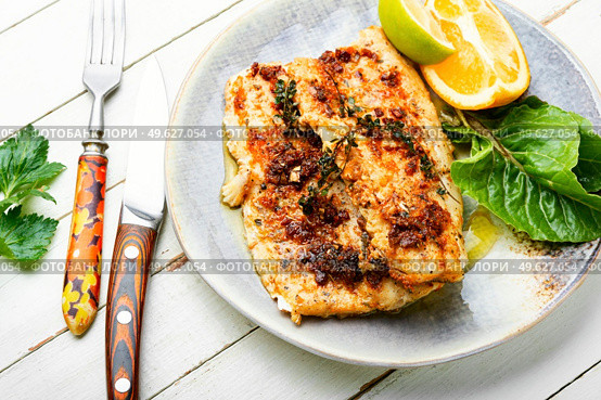 Tasty baked fish, fried pike perch in orange sauce.. Roasted fish fillets. Стоковое фото, агентство Ingram Publishing / Фотобанк Лори