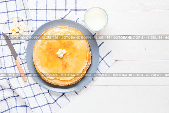 Tasty blini with butter and milk on table. Стоковое фото, фотограф Pixel_shot / Фотобанк Лори