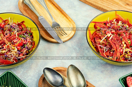 Tasty salad made from a mixture of sprouted alfalfa, beans, red radish with pomegranate and black carrots.. Diet vegan sprouts salad. Стоковое фото, агентство Ingram Publishing / Фотобанк Лори