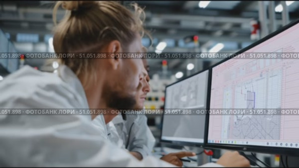 Team collaborates on technical project in modern workspace featuring advanced equipment and innovative design. Стоковое AI-видео, аниматор Сергей Толмачёв / Фотобанк Лори