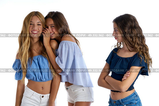 Teen best friends bullying a girl sad apart out of the game on white background. Стоковое фото, агентство Ingram Publishing / Фотобанк Лори