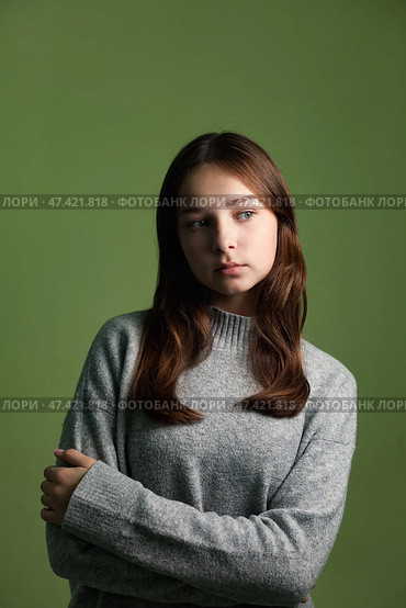 Teen Girl Expressing Emotion in a Studio Setting With Neutral Backdrop. Стоковое фото, фотограф Aleksandr Golubev / Фотобанк Лори