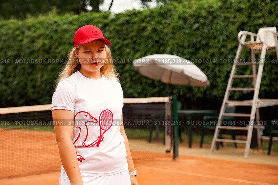Teenage Girl Focuses on Improving Her Game During Outdoor Tennis Practice on a Sunny Day. Стоковое фото, фотограф Aleksandr Golubev / Фотобанк Лори