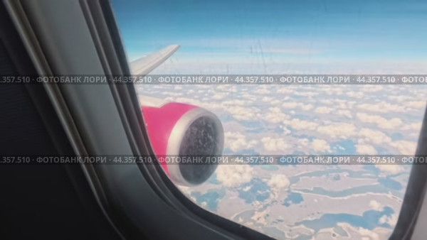 The camera approaches the porthole during the flight and reveals the beauty outside the plane. Стоковое видео, видеограф Ярославский Максим / Фотобанк Лори