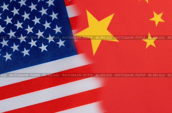 The flag of the United States and China with portraits of the dollar and the yuan. Стоковое фото, фотограф Igor Skripachev / Фотобанк Лори