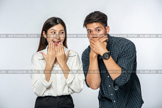 The men and women wore shirts and covered their mouths with their hands in shock. Стоковое фото, агентство Ingram Publishing / Фотобанк Лори