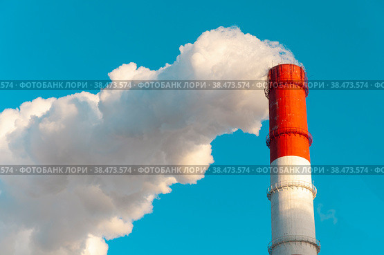 The pipe of the thermal power plant on the background of the blue sky. The concept of ecology and environmental protection. Стоковое фото, фотограф Ярославский Максим / Фотобанк Лори