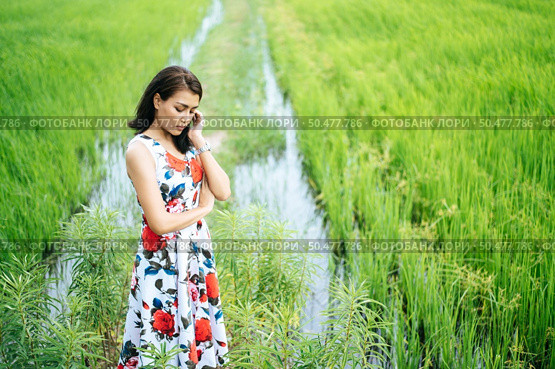 The woman stood strained and her hand touched the face in the meadow. Стоковое фото, агентство Ingram Publishing / Фотобанк Лори
