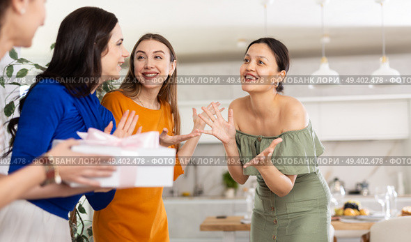 Three women have arrived for birthday celebration and presenting gift to birthday woman. Стоковое фото, фотограф Яков Филимонов / Фотобанк Лори