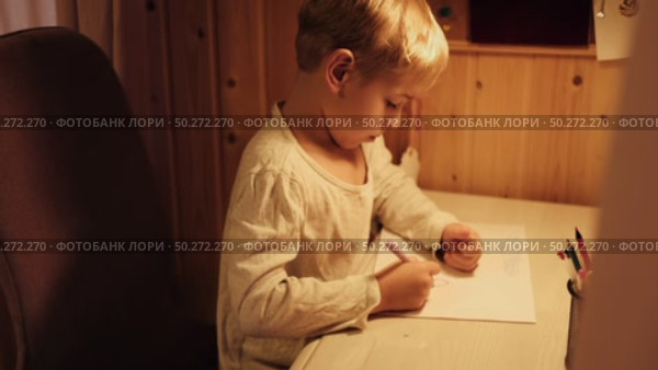 Toddler Child Drawing Sitting At Table. Activities to Foster Creativity in a Cozy Home Setting. Young kid boy diligently focused on his vibrant drawing. Imagination. Happy little boy coloring. Стоковое видео, видеограф Марина Демидюк / Фотобанк Лори