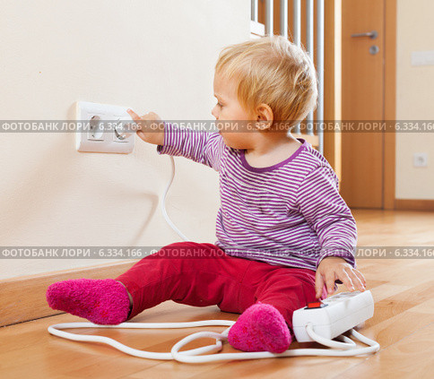Toddler playing with extension cord and outlet. Стоковое фото, фотограф Яков Филимонов / Фотобанк Лори