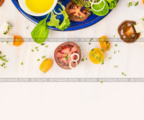 Tomatoes salad making with oil and cress on white wooden background, top view. Стоковое фото, агентство Ingram Publishing / Фотобанк Лори